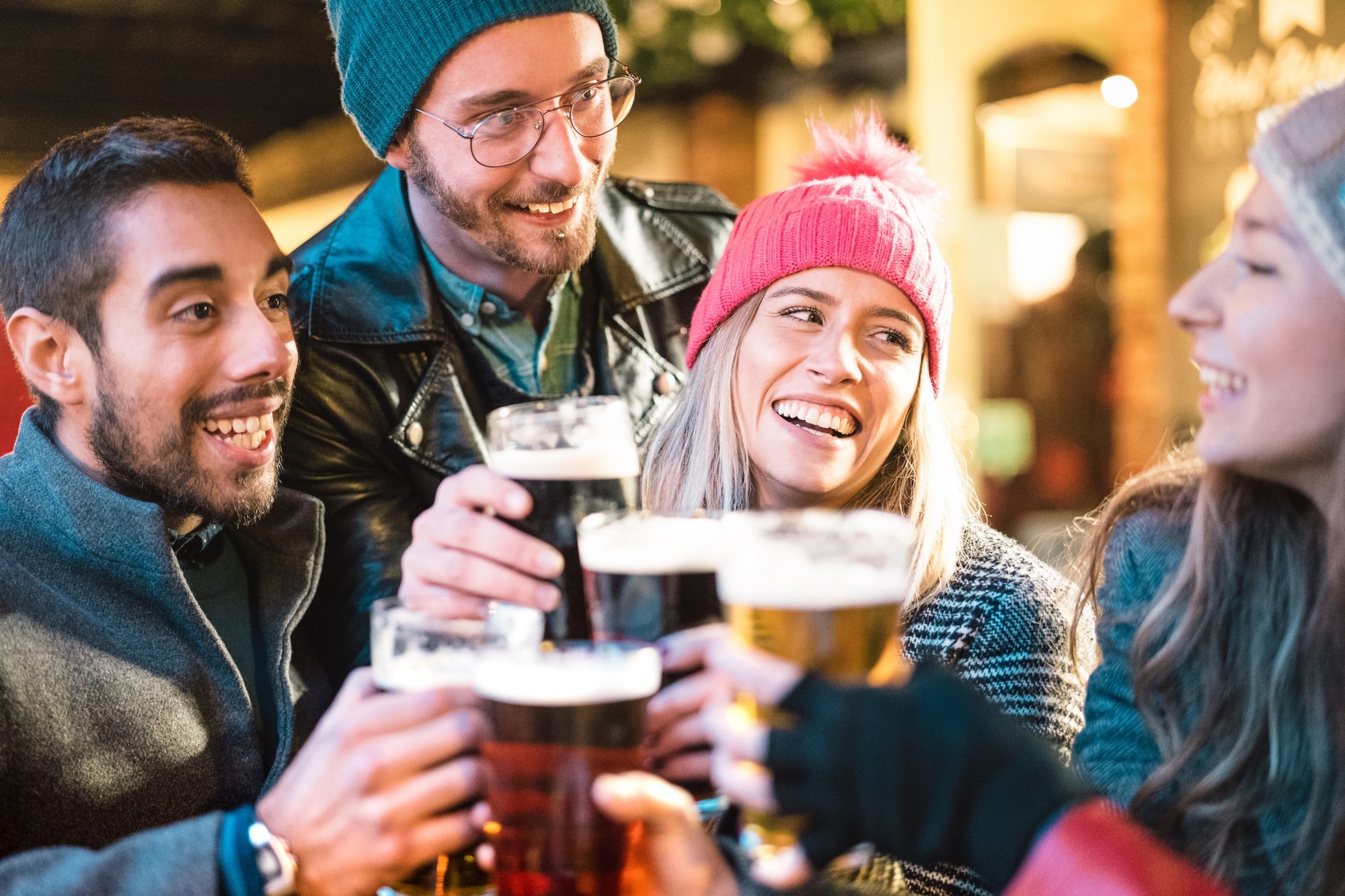 Friends drinking beer at brewery bar outdoor on winter time